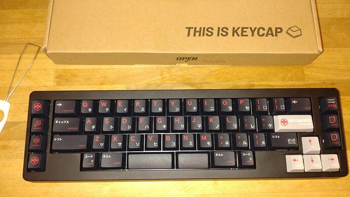 A Kbdfans D45 50% keyboard with Arasaka Corporation themed red/white on black keycaps (Enter and cursor keys red on light grey)